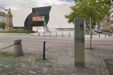 Vergrößerte Ansicht von Veteranendenkmal im Hintergrund mit Stadttafel
